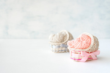 Obraz premium Pink and blue decorative straw cradles with thread hearts. Baby shower ideas, birthday, girl and boy, party, newborn