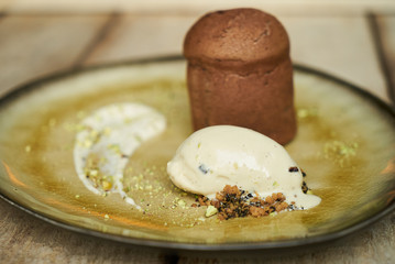 Fondant cake dessert and pistachio ice cream with English cream, pistachio crumble and sauce bailies