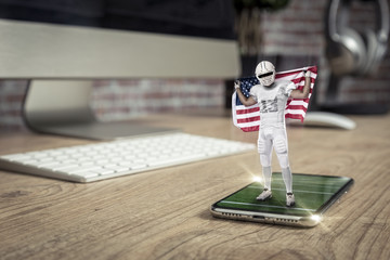 Football Player with a white uniform playing and coming out of a full screen phone on a wooden...