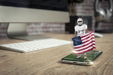 Football Player with a white uniform playing and coming out of a full screen phone on a wooden...