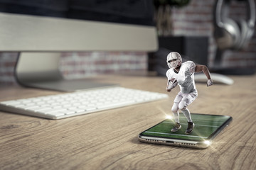 Football Player with a white uniform playing and coming out of a full screen phone on a wooden...