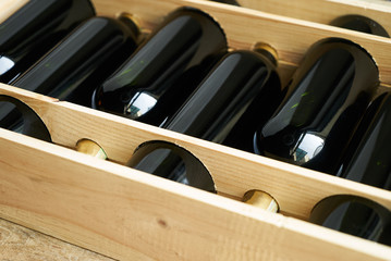 Top view of a case of cabernet sauvignon wine bottles. Wooden box with collection of six wine bottle