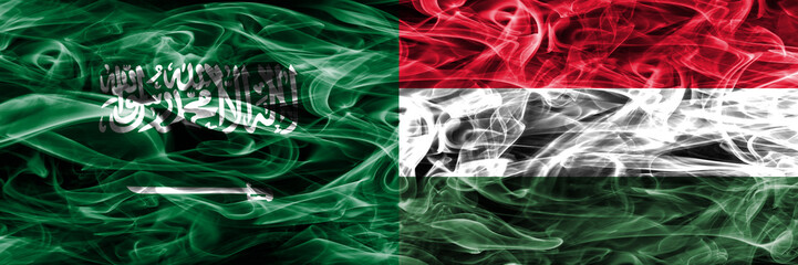 Saudi Arabia vs Hungary smoke flags placed side by side. Thick colored silky smoke flags of Saudi Arabia and Hungary.