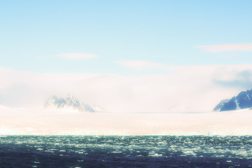 Edge of Ice Pack in the Arctic Ocean with Foggy Mountains in the Background off the Coast of Norway
