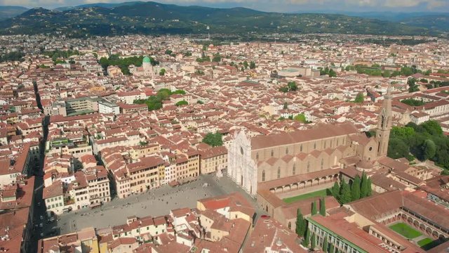 Florence aerial cityscape view on the old town with Santa Croce church and Santa Croce Plazza in Italy. 4K drone vide.