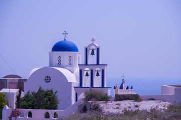 White Chapel with blue dome in Santorini, Greece
