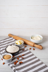 Baking ingredients on kitchen table white background, top view.