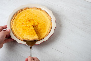 Baked sweet cheesecake served on plate on white background, copy text recipe.