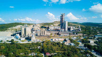 Aerial view of cement manufacturing plant. Concept of buildings at the factory, steel pipes, giants.