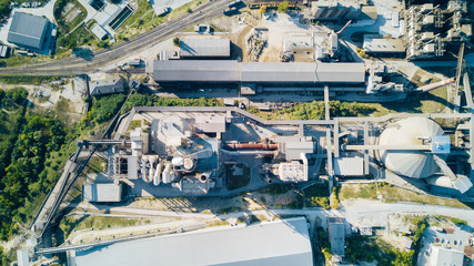 Aerial view of cement manufacturing plant. Concept of buildings at the factory, steel pipes, giants.