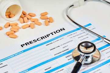 prescription order form on phonendoscope background and tablets