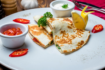 Quesadilla with chicken and sauces