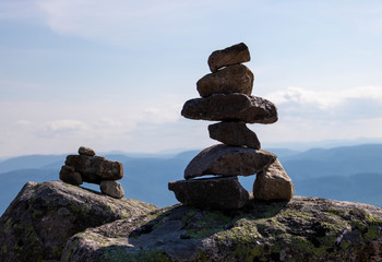 Two cairns (Inukshuk rocks) on top of a mountain in the Grands-Jardins National Park in the Charlevoix Region in Quebec, Canada. 