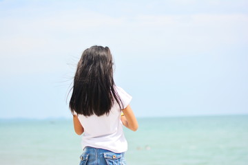 Little girl taking selfie by smartphone on the beach. Girl is a happy and relax in the holiday. 