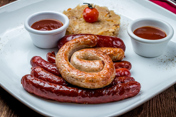 assorted sausages with sauces