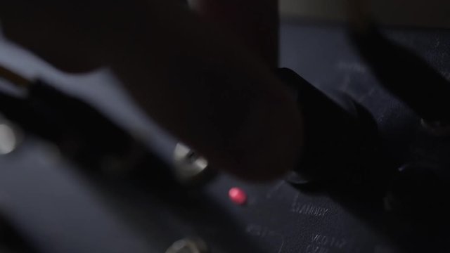 Turning on power button on music instrument sampler