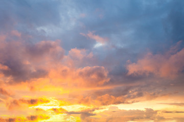 Fototapeta premium view of a warm orange sunset with clouds in pastel colors