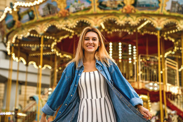 portrait of a girl in American style on a swing laughs and rejoices