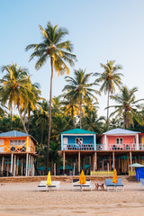Tropical palm trees and bungalow in Palolem beach, Goa, India - obrazy, fototapety, plakaty