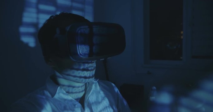 Futuristic Man programmer wearing virtual reality hemlet or VR Glasses with binary code reflection