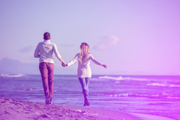 Loving young couple on a beach at autumn sunny day