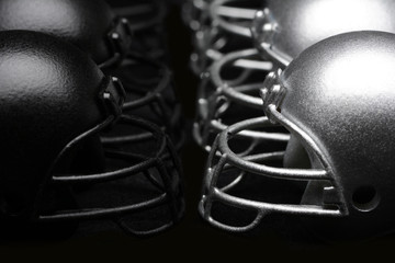 Black and Silver American Football helmets lined up