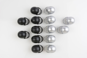 Football helmets lined up facing each other in play formation