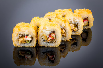 Hot roll with tempura crab on black with reflection