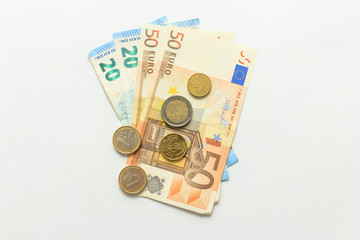 paper currency notes and coins euros, white background