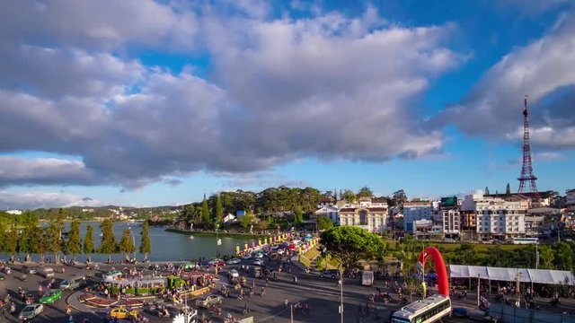 Timelapse or time lapse of a lot of unidentified people drive by motor, motorcycles, car, bus, truck and walking on street at roundabout in Dalat center market, Vietnam. Timelapse is fast video