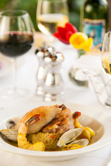 Shrimp and clam seafood appetizer on a white plate.