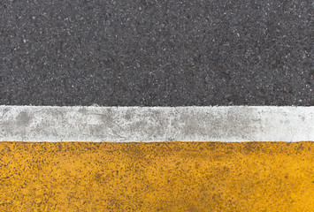 Background of yellow black strips . Dark grey asphalt road divided by yellow paint. yellow black background. using for book cover or your design..