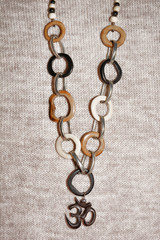 Indian jewelry with the OM symbol on the background burlap  