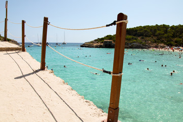 Fototapeta premium Beautiful view of roped walkway in front of clear blue azure sea