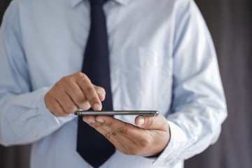 Business man hold the smartphone on the street  and copy space.