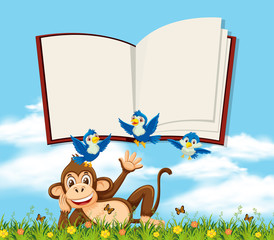 A monkey in nature with blank book template