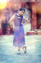The style beautiful fashion Model Girl indian asian caucasian child standing looking at camera hand on hips