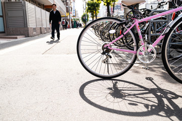 a cityscape of bicycles parked in the walkway