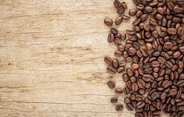 Coffee beans on old wood background