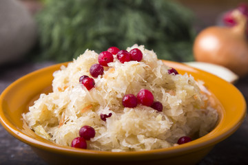 Tasty sauerkraut with onion and cranberry in a plate.