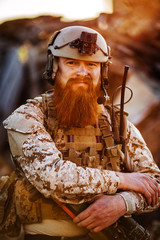 rangers with assault rifles on battlefield background. army, military and people concep