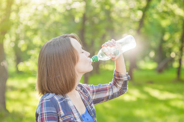 Young woman drinking water outdoor