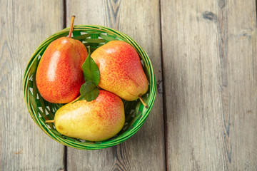 Ripe pears on rustic wooden table