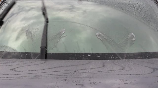 HD video footage showing car windshield wiper and washer in action