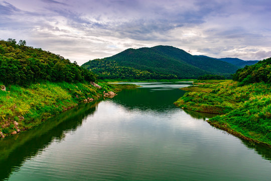 Landscape picture of river, mountain, forest and cloudy sky in rainy day.