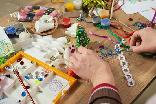 Childrens making decorations for new year holiday. Painting watercolors. Top view. Artwork workplace with creative accessories.