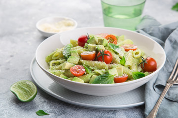 penne pasta with creamy avocado sauce and tomatoes