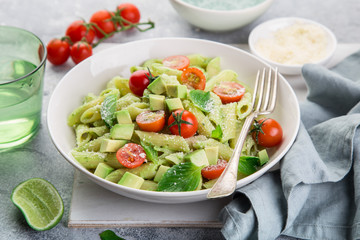 penne pasta with creamy avocado sauce and tomatoes