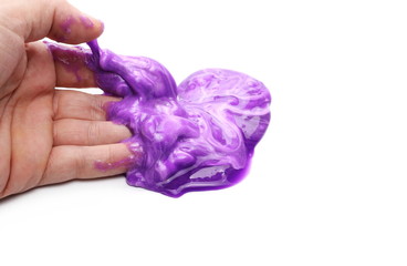 Purple sleaze puddle, slime in hand isolated on white background, with clipping path