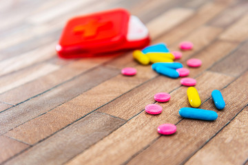 Health concept colorful medication and pills spilling out of a toppled bright bottle